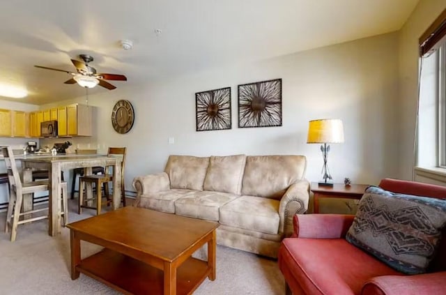 living area featuring light carpet, plenty of natural light, and ceiling fan