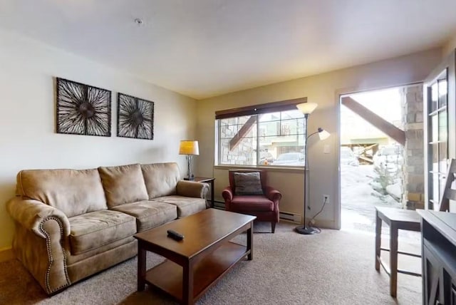 living room with baseboard heating and carpet