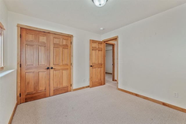 unfurnished bedroom with light colored carpet