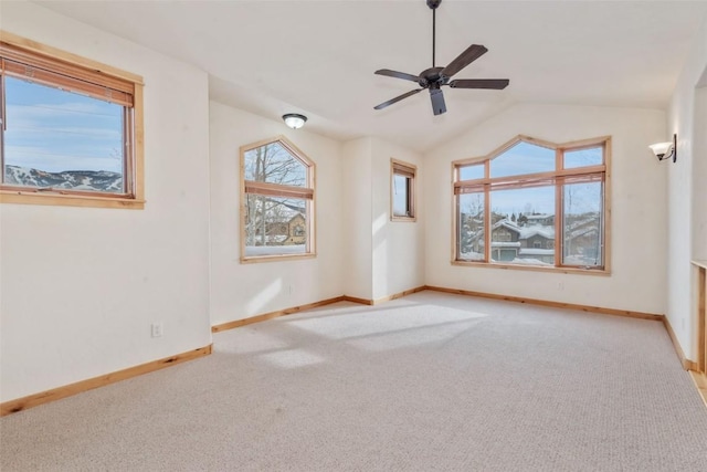 carpeted empty room featuring lofted ceiling and ceiling fan