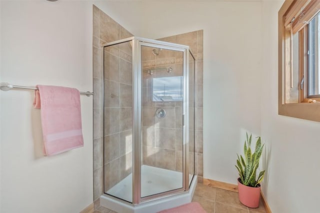 bathroom featuring tile patterned flooring and a shower with door