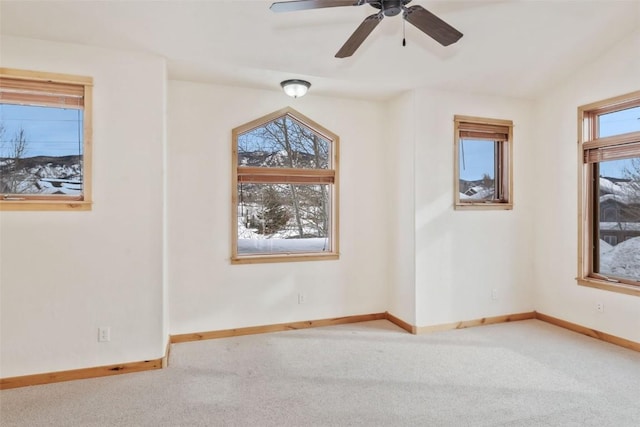 carpeted spare room with vaulted ceiling