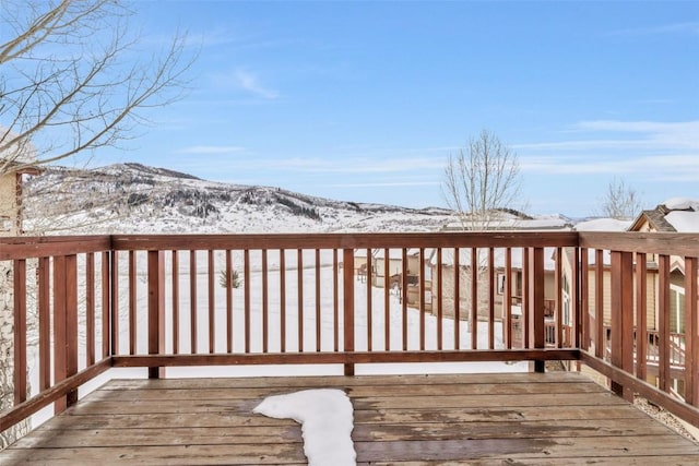 snow covered deck featuring a mountain view