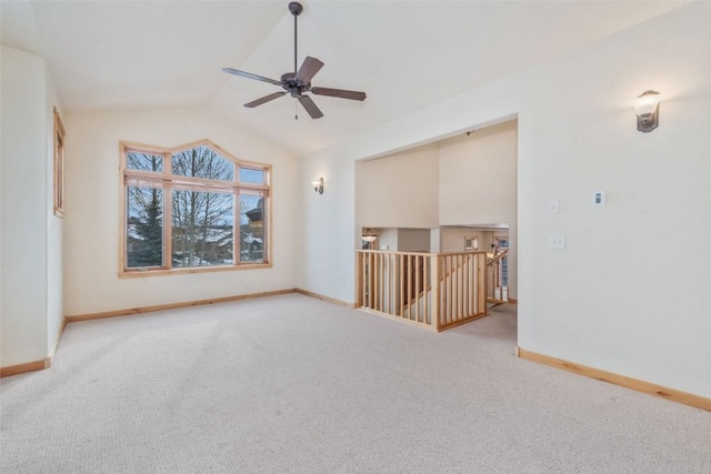 unfurnished room with ceiling fan, lofted ceiling, and light carpet