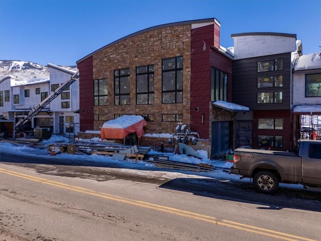 snow covered building with a mountain view