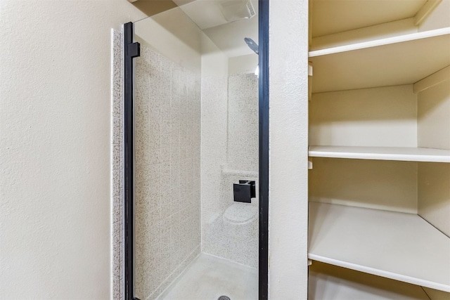 bathroom with a shower with shower door