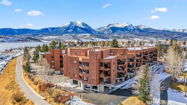 snowy aerial view with a mountain view