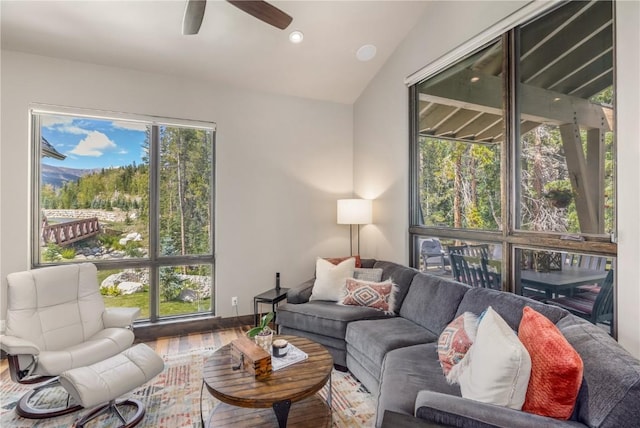 living room featuring ceiling fan, lofted ceiling, and hardwood / wood-style flooring