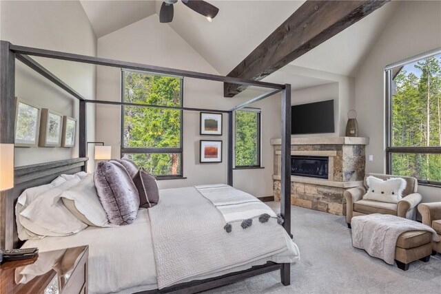 carpeted bedroom with multiple windows, vaulted ceiling, and ceiling fan