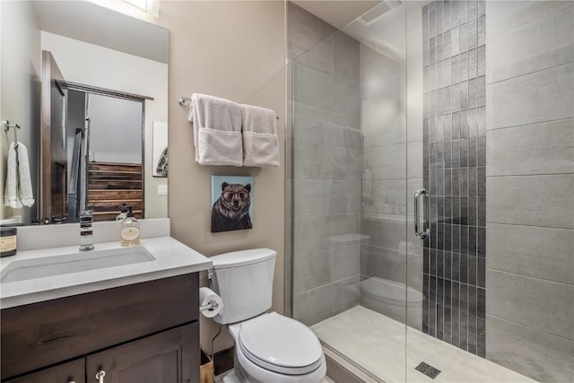 bathroom with vanity, an enclosed shower, and toilet