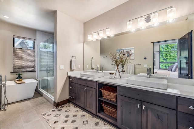 bathroom with plus walk in shower, tile patterned flooring, and vanity