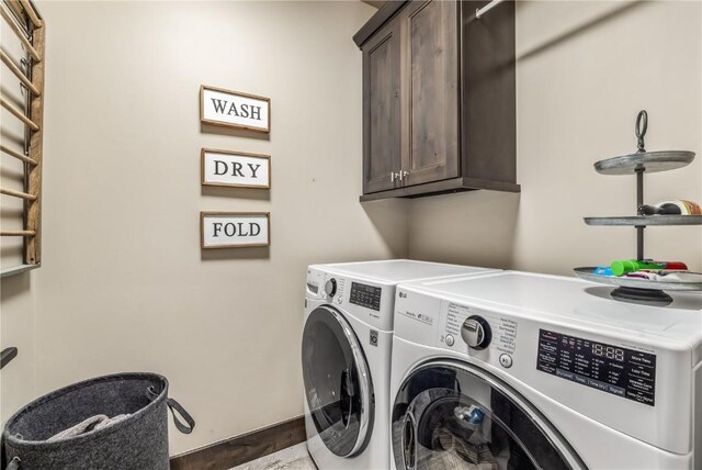 laundry room with cabinets and washing machine and dryer