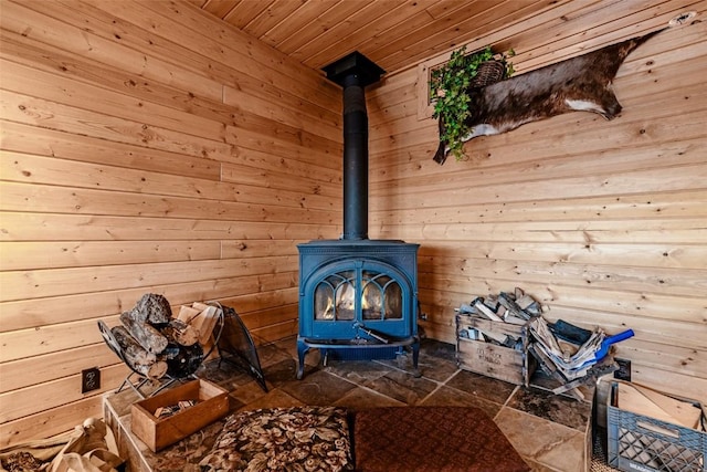 interior details with wood ceiling, wood walls, and a wood stove