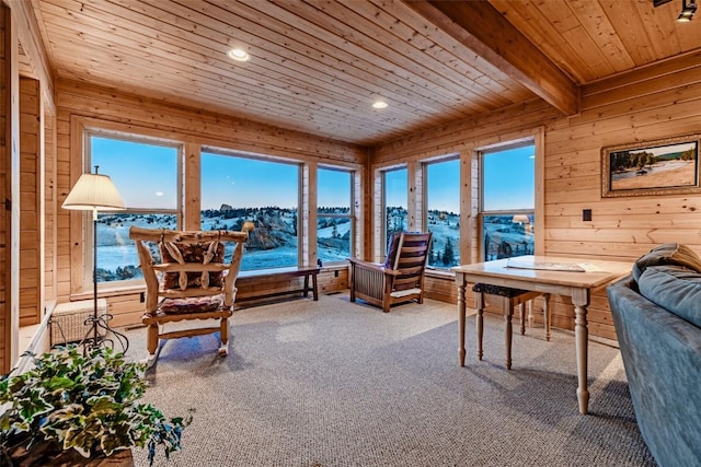 sunroom with beamed ceiling, wood ceiling, and a healthy amount of sunlight