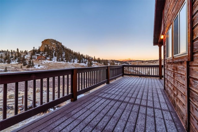 snow covered deck featuring a mountain view