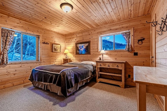 bedroom with wooden ceiling, carpet, and wooden walls