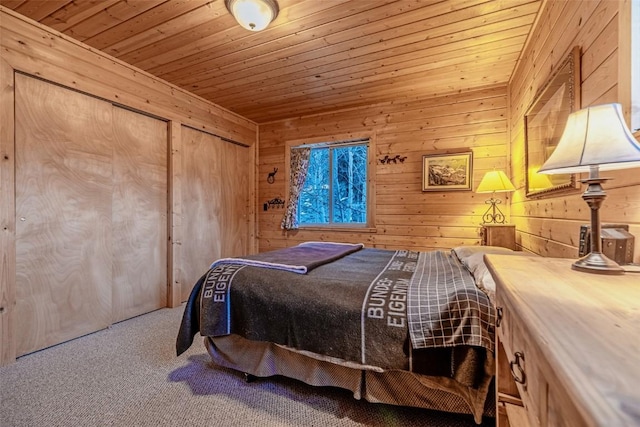 bedroom with carpet, wood ceiling, and wood walls