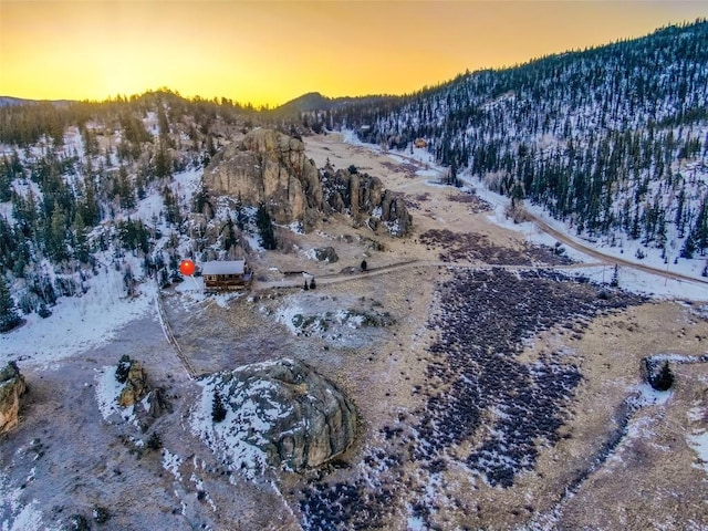 aerial view at dusk featuring a mountain view