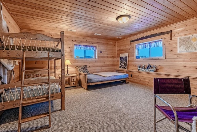 bedroom with carpet floors, wood ceiling, and multiple windows