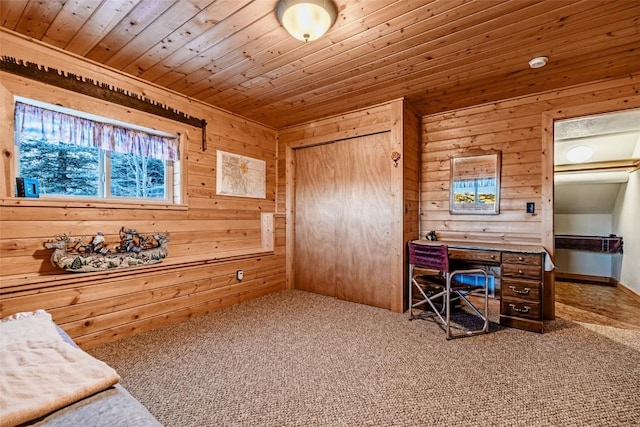 carpeted office featuring wooden ceiling and wooden walls