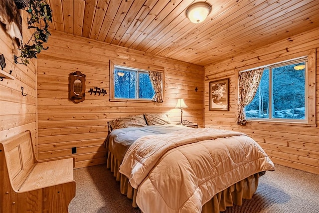 bedroom with wooden ceiling, carpet flooring, and wooden walls