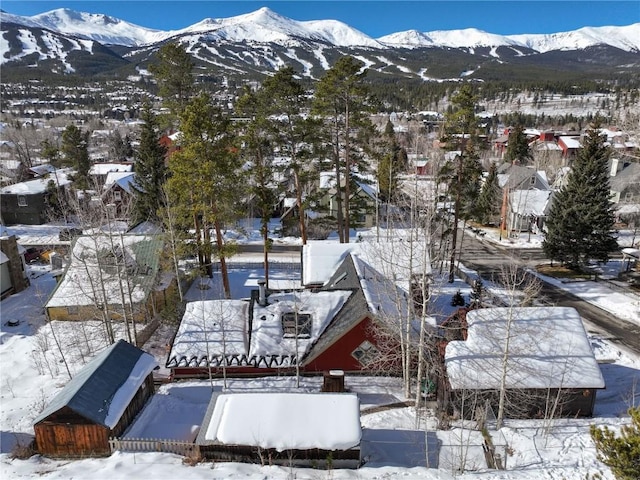 snowy aerial view with a mountain view