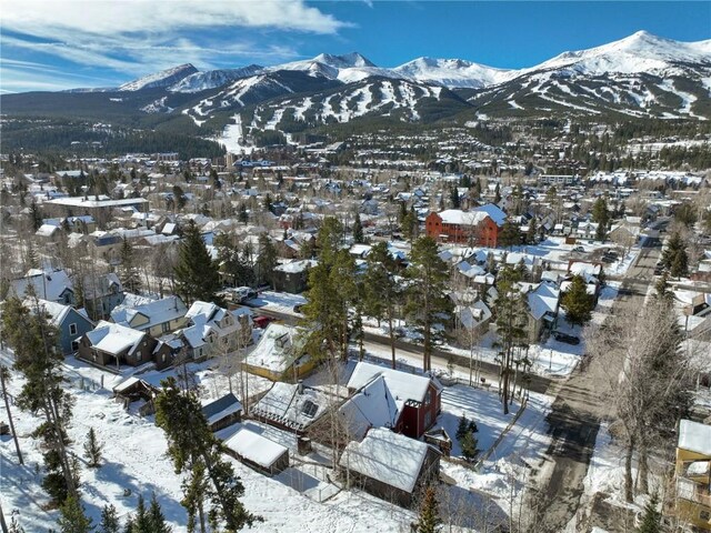 snowy aerial view with a mountain view