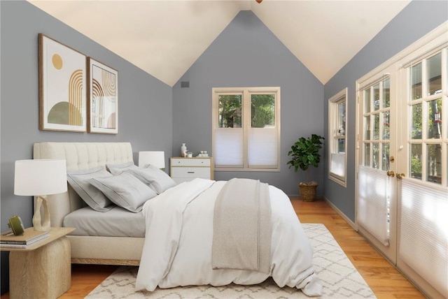 bedroom featuring light hardwood / wood-style flooring and vaulted ceiling