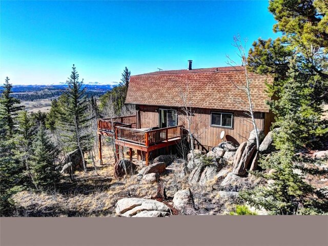 rear view of property with a wooden deck