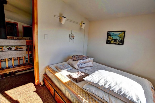 carpeted bedroom featuring vaulted ceiling