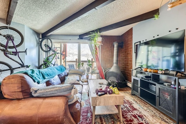 living room featuring baseboard heating, lofted ceiling with beams, a textured ceiling, and a wood stove