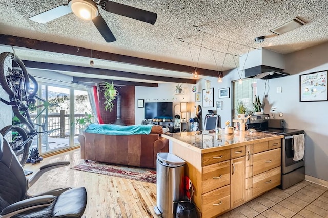 kitchen featuring beamed ceiling, a textured ceiling, and electric range