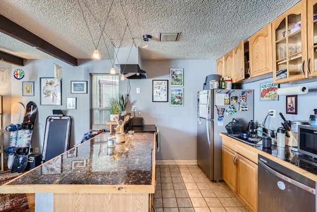 kitchen with light tile patterned flooring, stainless steel appliances, light brown cabinetry, and a textured ceiling