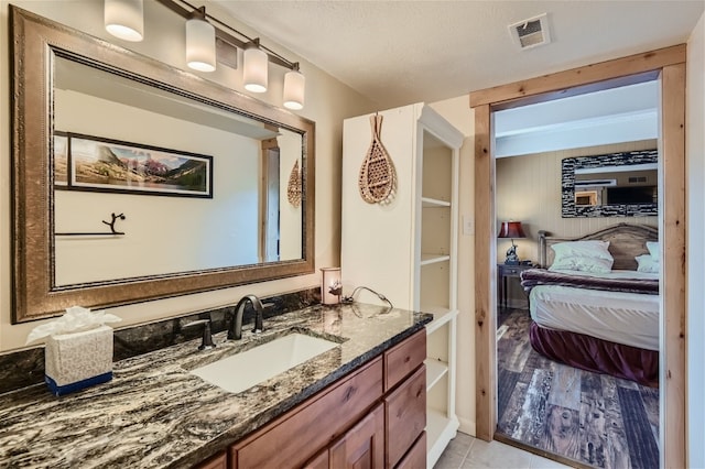 bathroom with vanity and a textured ceiling