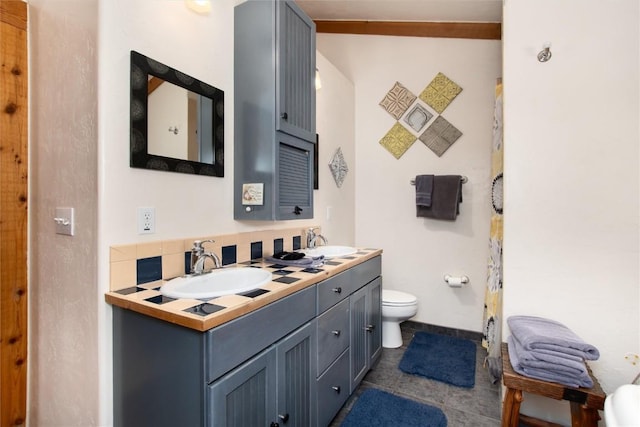 bathroom featuring tile patterned floors, vanity, and toilet