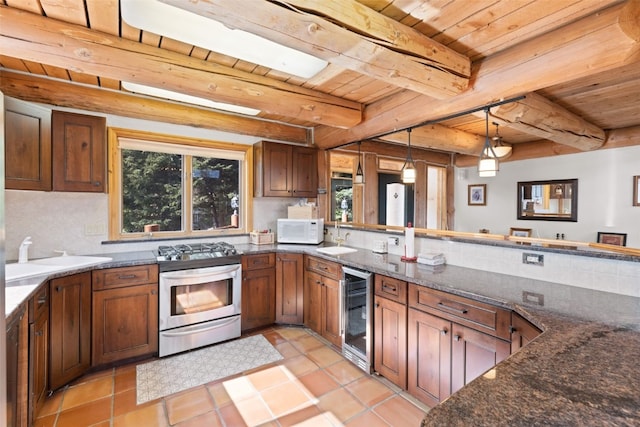 kitchen with hanging light fixtures, beam ceiling, wood ceiling, beverage cooler, and gas stove