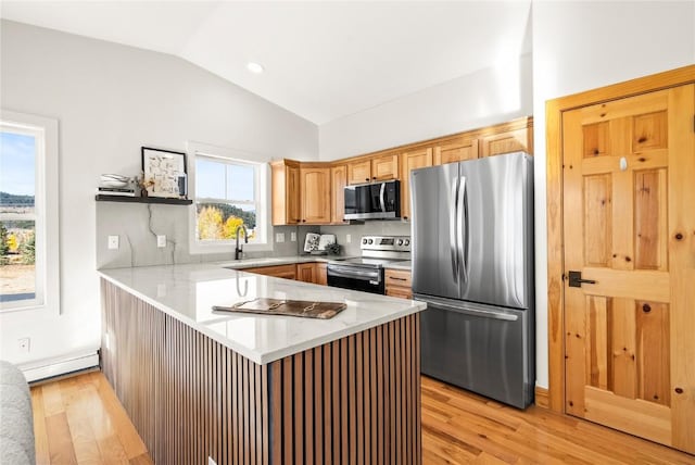 kitchen with kitchen peninsula, appliances with stainless steel finishes, vaulted ceiling, baseboard heating, and light hardwood / wood-style flooring