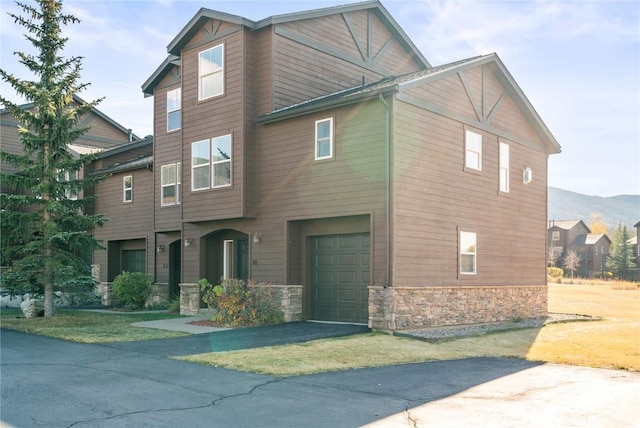 view of front of property with a mountain view and a garage