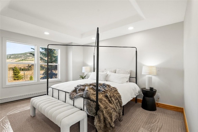 bedroom featuring carpet flooring, a tray ceiling, and a baseboard radiator