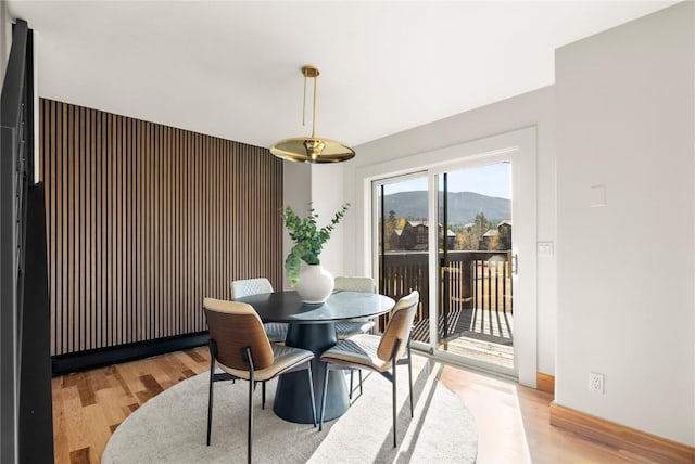 dining space with a mountain view and wood-type flooring