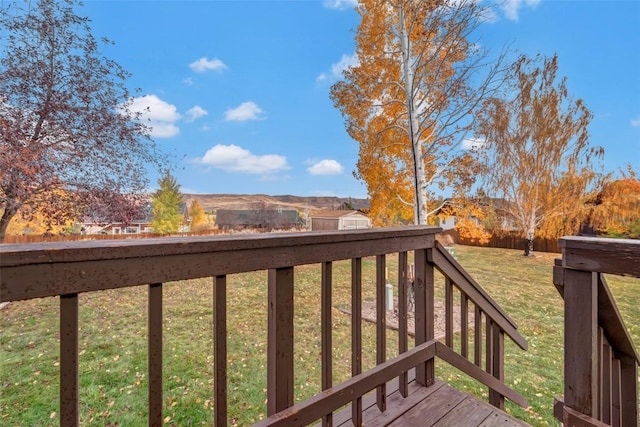 wooden deck with a lawn