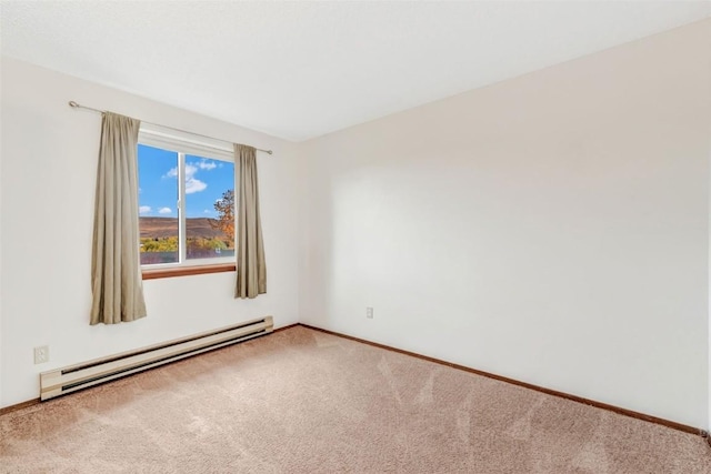 carpeted spare room with a baseboard radiator