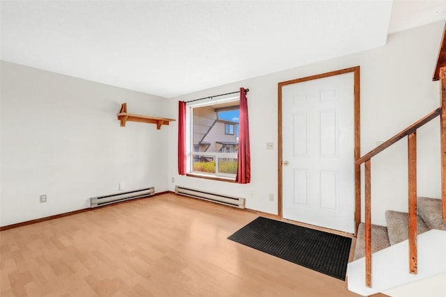 foyer entrance with light wood-type flooring and baseboard heating