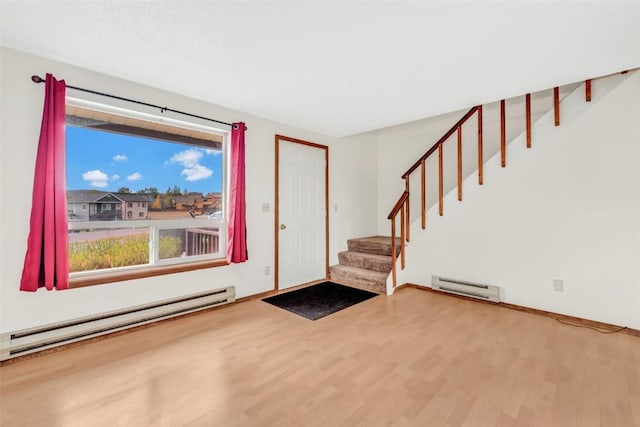 entryway with hardwood / wood-style floors, a wealth of natural light, and baseboard heating