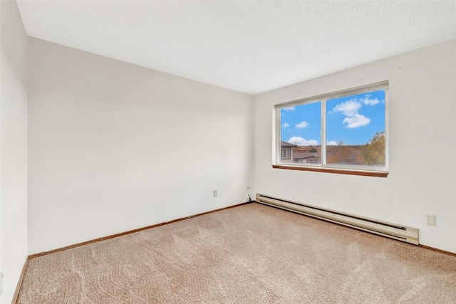 carpeted empty room featuring a baseboard heating unit