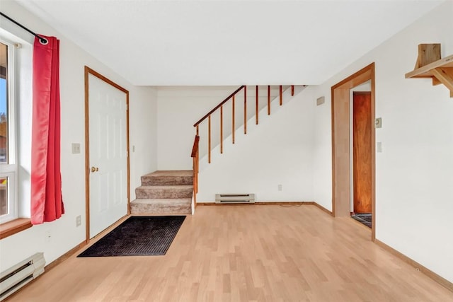 foyer with baseboard heating and hardwood / wood-style floors