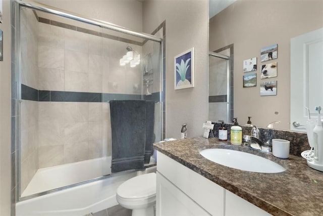 full bathroom with toilet, vanity, and bath / shower combo with glass door