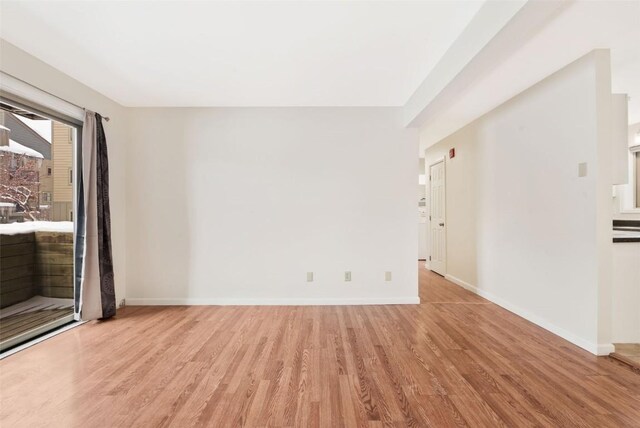 unfurnished room with light wood-type flooring