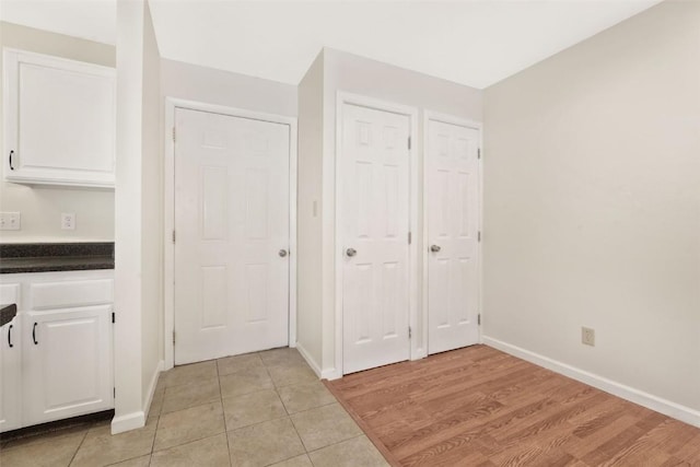 interior space featuring white cabinetry and light tile patterned flooring