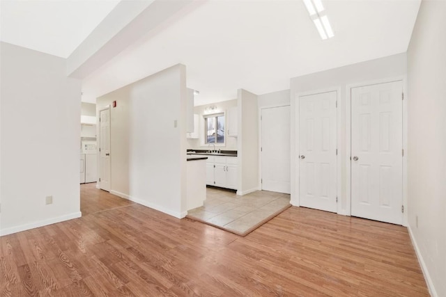 interior space with washer / clothes dryer and light hardwood / wood-style flooring